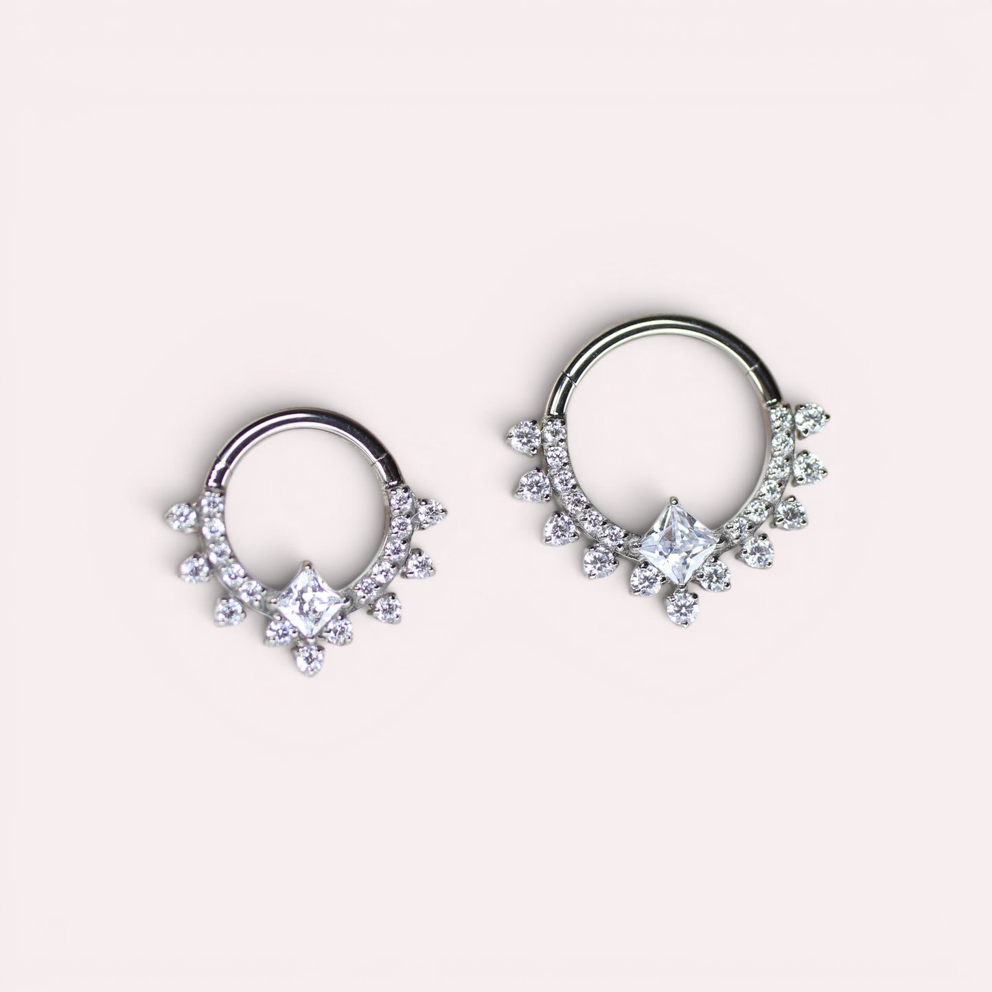 MKBodyJewelry silver titanium septum clicker ring with sparkling CZ crystals and a central square stone.