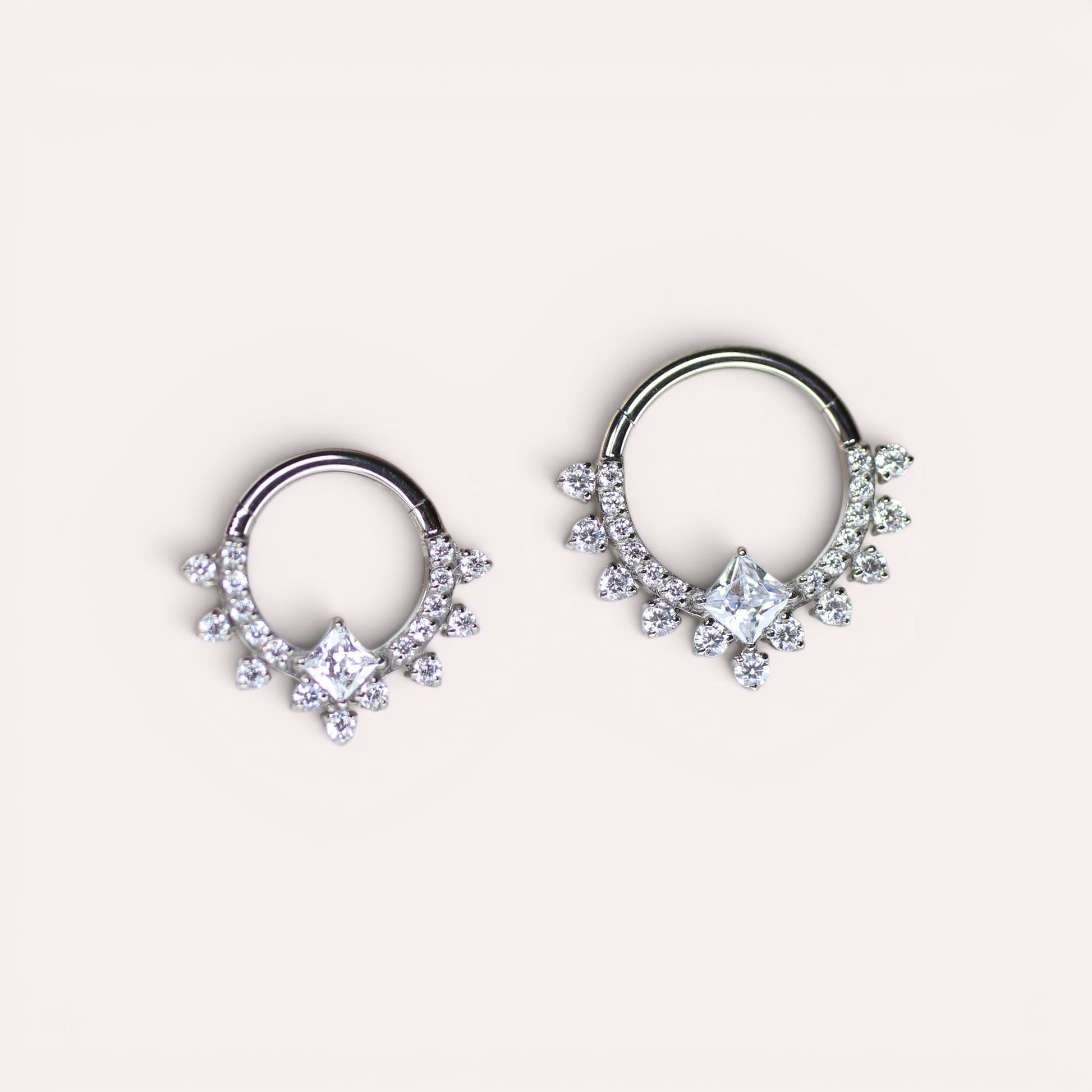 MKBodyJewelry silver titanium septum clicker ring with sparkling CZ crystals and a central square stone.