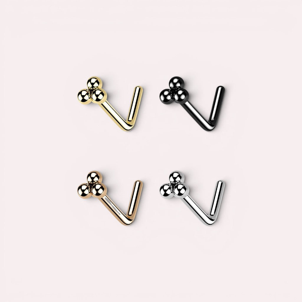 MKBodyJewelry triple ball L-shaped nose studs in gold, black, rose gold, and silver metallic finishes.