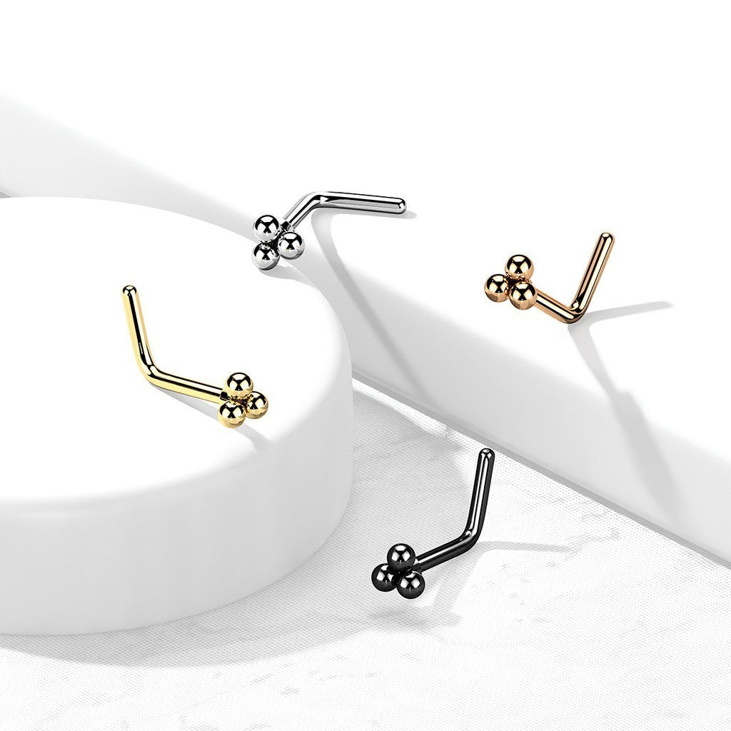 MKBodyJewelry L-shaped nose studs featuring a triple-bead cluster in silver, gold, rose gold, and black metal finishes.
